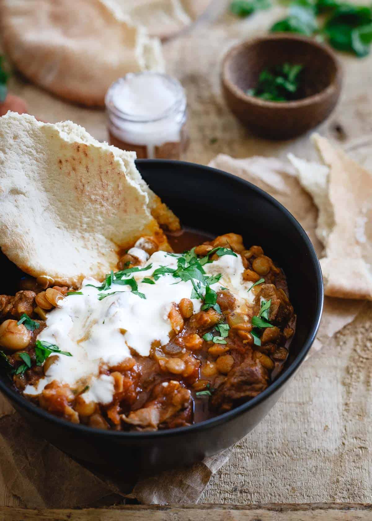 Moroccan lamb lentil stew with lots of fresh cilantro and a dollop of yogurt 
