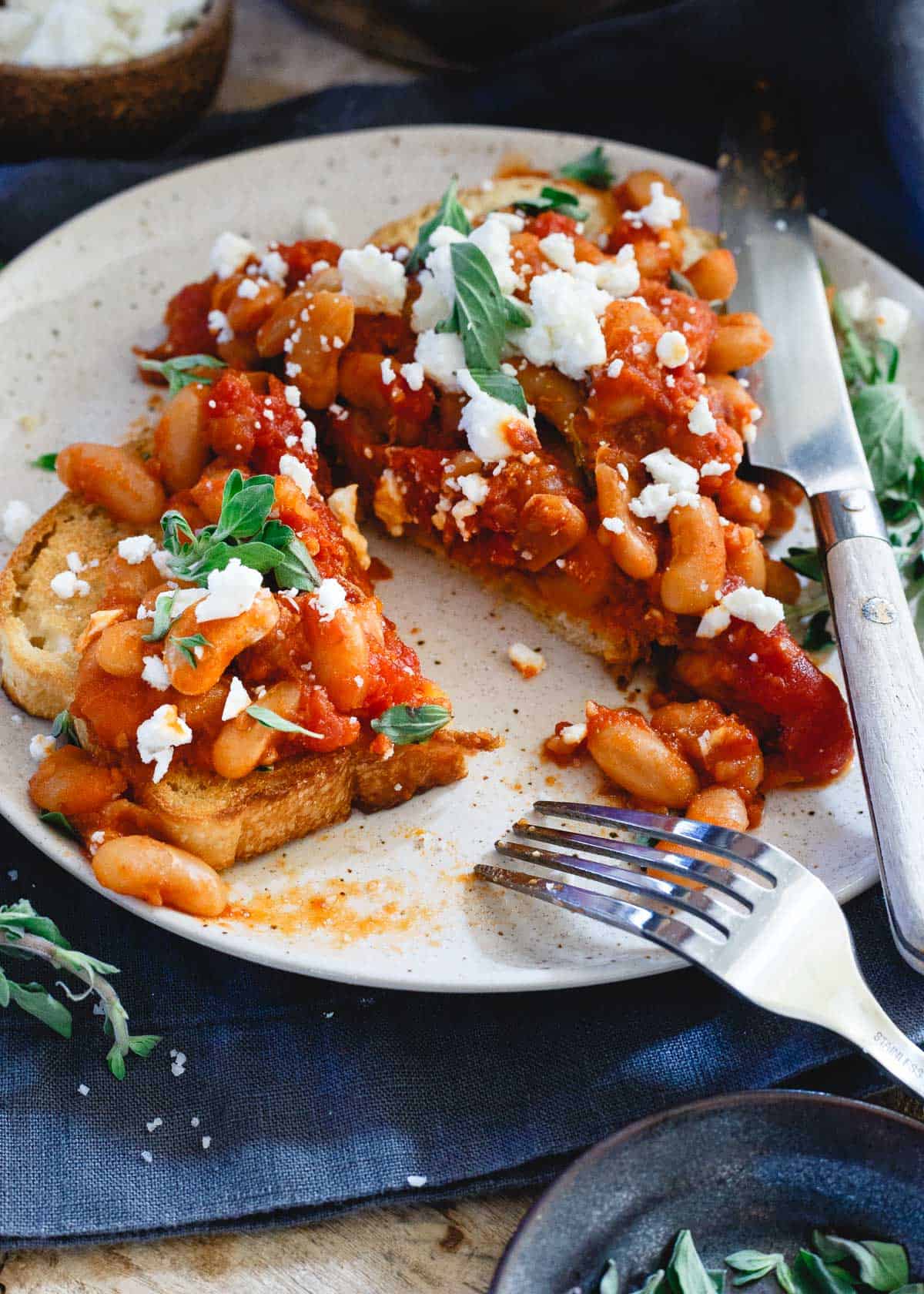 Top these Instant Pot tomato white beans with some feta and fresh oregano for a wonderfully hearty winter meal.