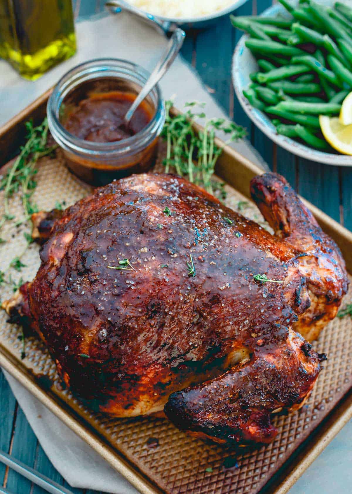 This apple butter roasted chicken is a killer combination of sweet and savory flavors. With a crispy outside and a juicy, tender inside, it's the perfect Sunday dinner!