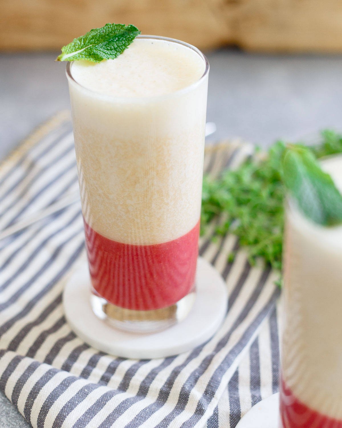 A refreshing strawberry ginger bottom layer and a sweet banana peach layer combine in this tasty smoothie.