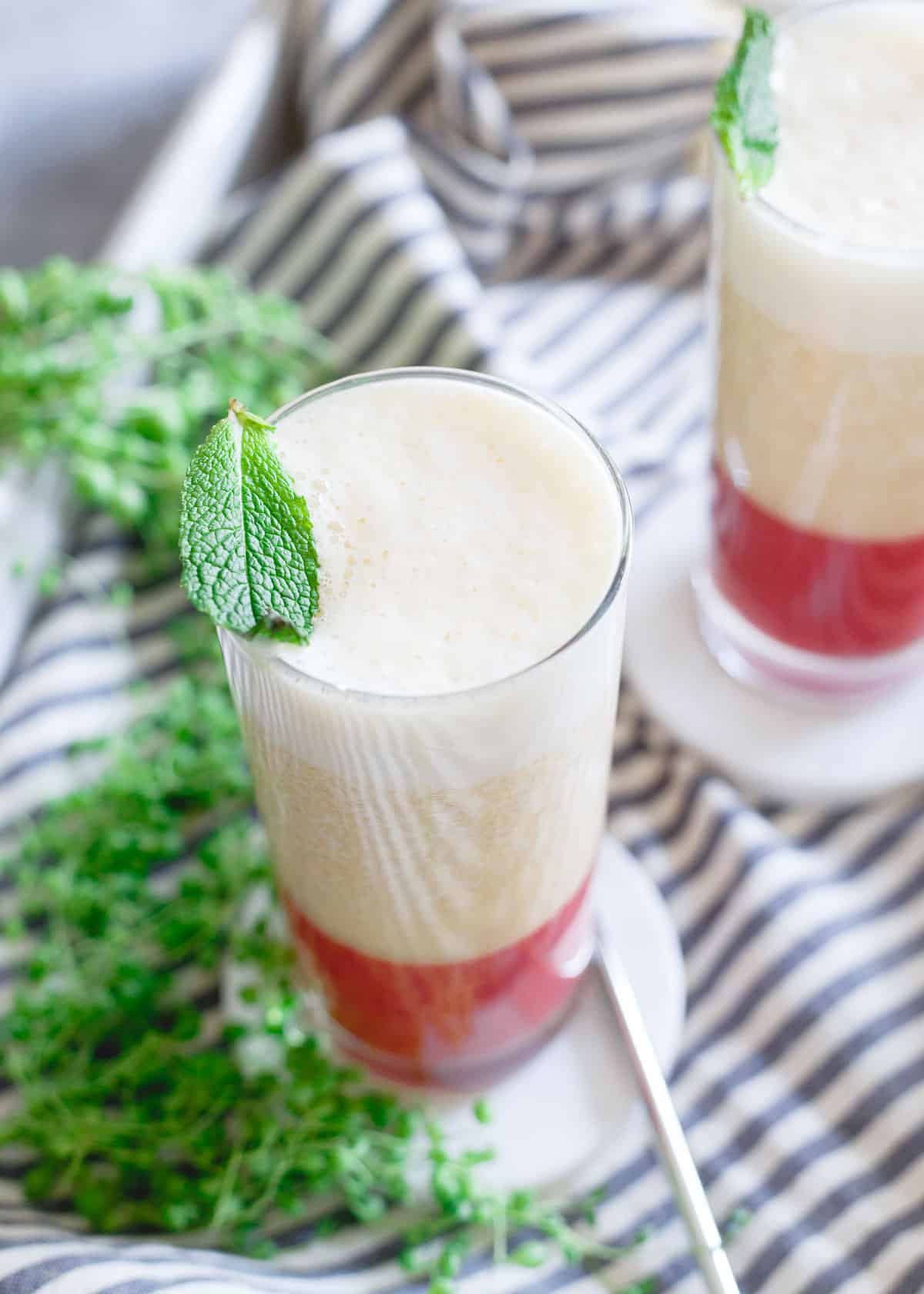 Strawberry ginger puree is a refreshing bottom layer to this peach banana smoothie.