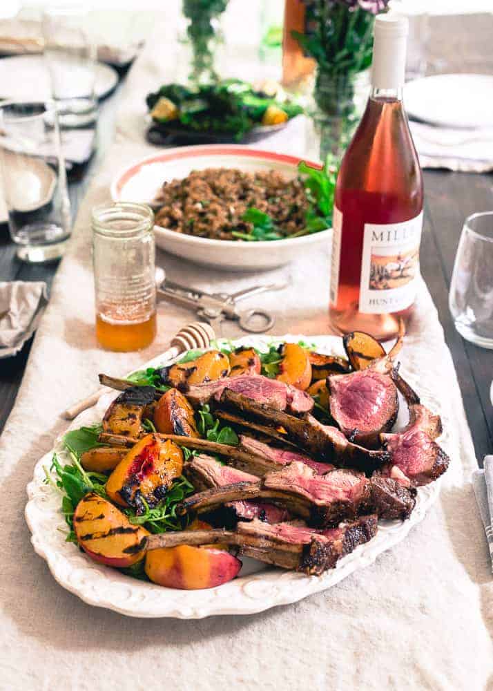 These grilled lamb chops are glazed with sweet peach honey and served with a simple watercress and grilled peach salad for the perfect summer meal.