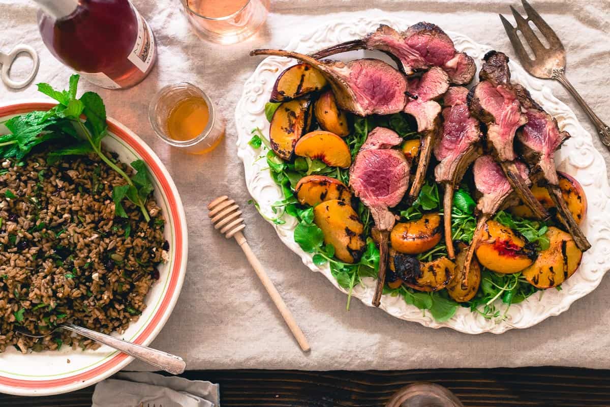 A summer spread of grilled lamb chops with peach honey and a wild rice, mint, dried cranberries, feta and seed mixture is an easy summer meal to entertain with.