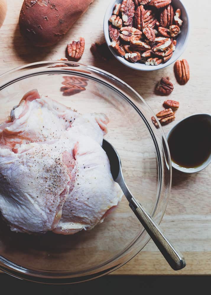 Chicken thighs roasted with sweet potatoes and pecans in a maple and mustard sauce.