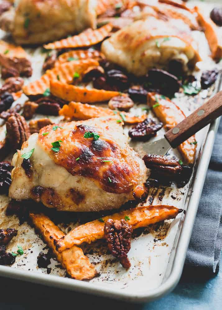 Crispy roasted chicken thighs with sweet potatoes and pecans in a fall inspired maple sauce.