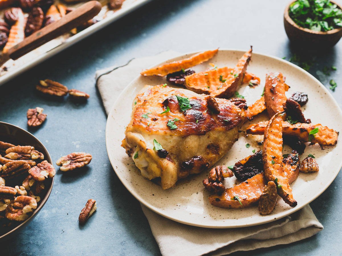 Serve this easy sheet pan chicken with sweet potatoes and pecans alongside your favorite green vegetable for a delicious dinner in under 30 minutes.