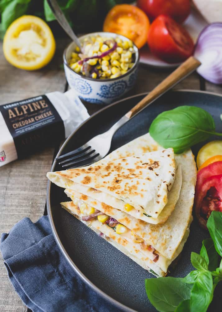 This cheddar quesadilla is filled with all the best end of summer produce like garden ripe tomatoes, fresh basil and sweet corn. It's a quick, easy, meatless meal to celebrate the season!