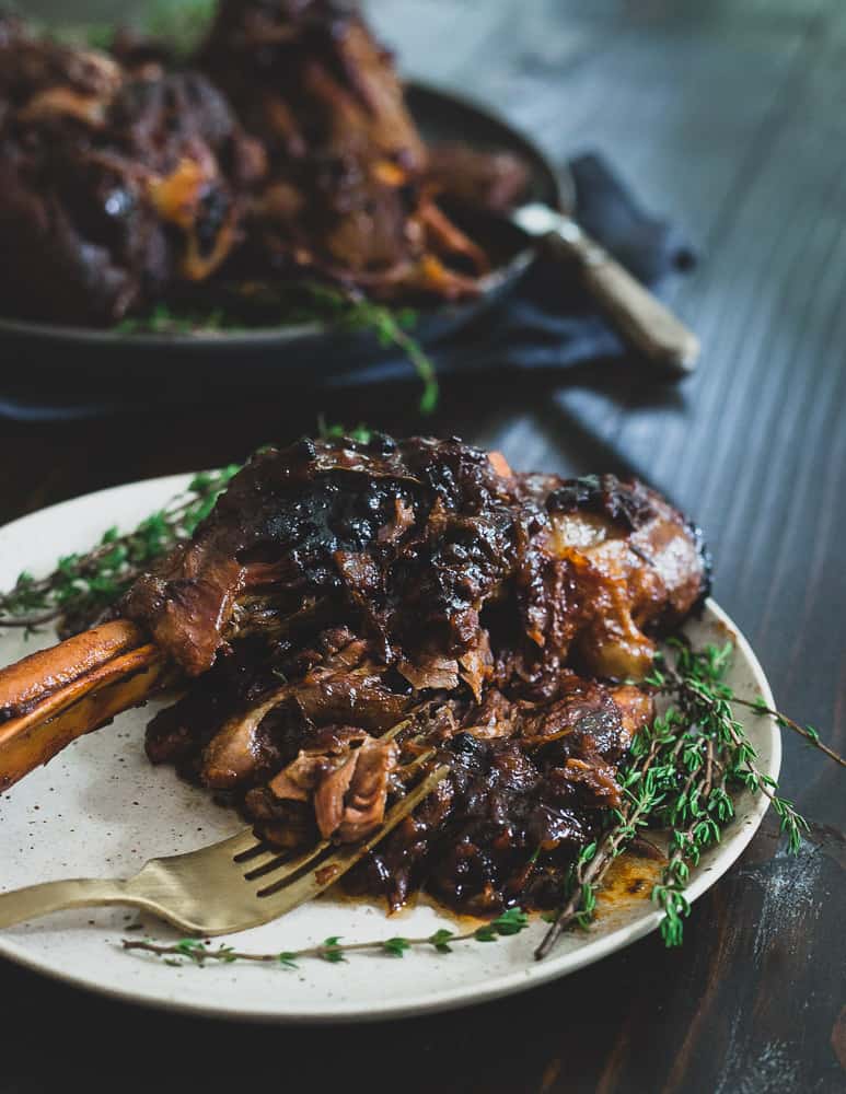 Close up of American lamb shank that was oven baked without wine next to a fork.