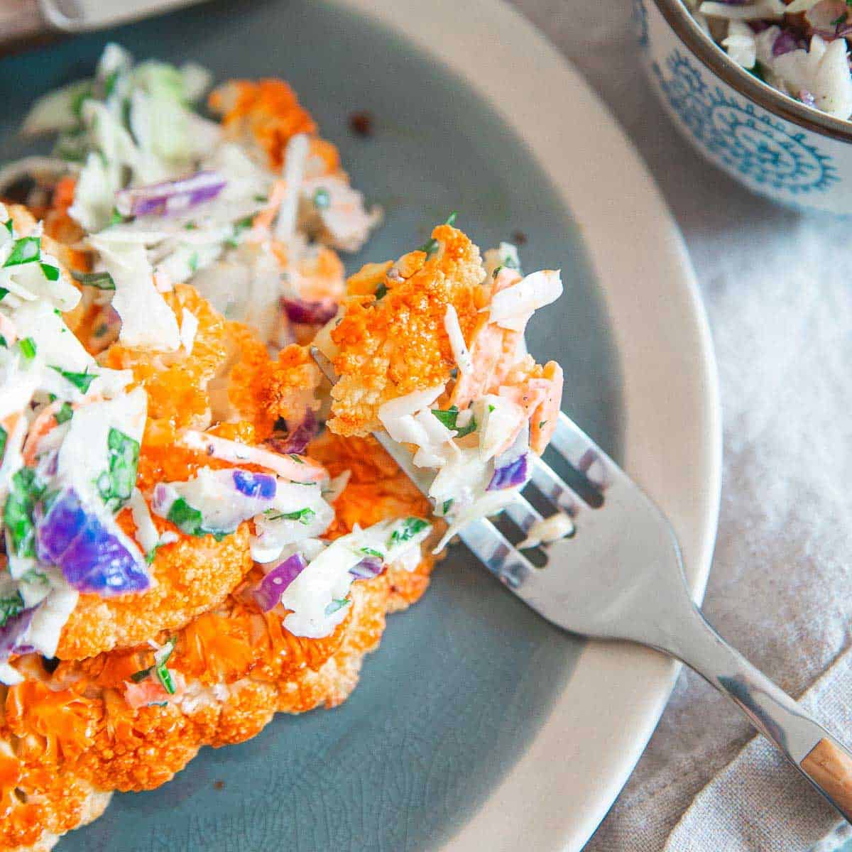 Get all the buffalo sauce flavor without the guilt in these buffalo cauliflower steaks with blue cheese coleslaw.