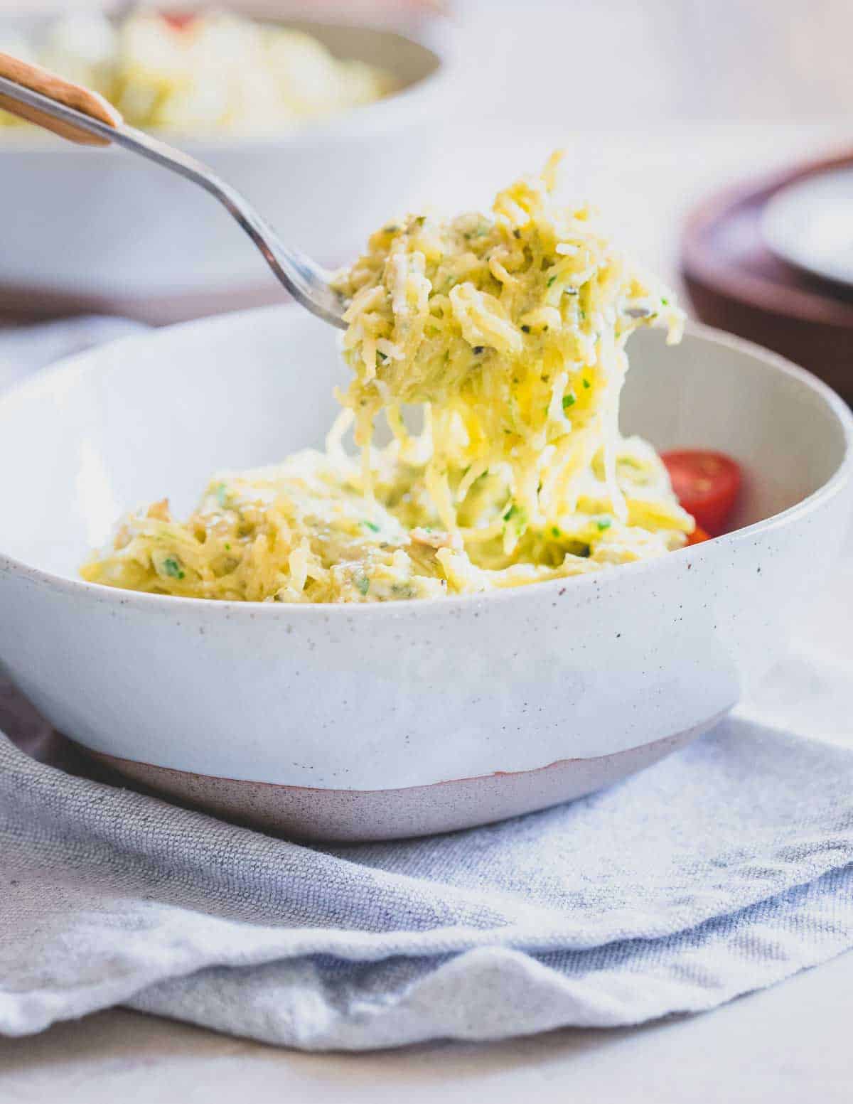 Enjoy the creaminess of a pesto pasta dish with spaghetti squash noodles for a healthier twist.