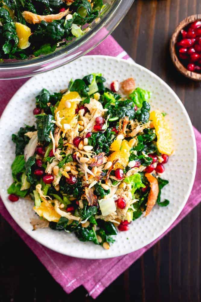 This chopped winter salad is packed with crispy rotisserie chicken, bright winter citrus, pomegranates, toasted pine nuts, fresh herbs and hearty bed of Tuscan kale then tossed in an orange dijon dressing.