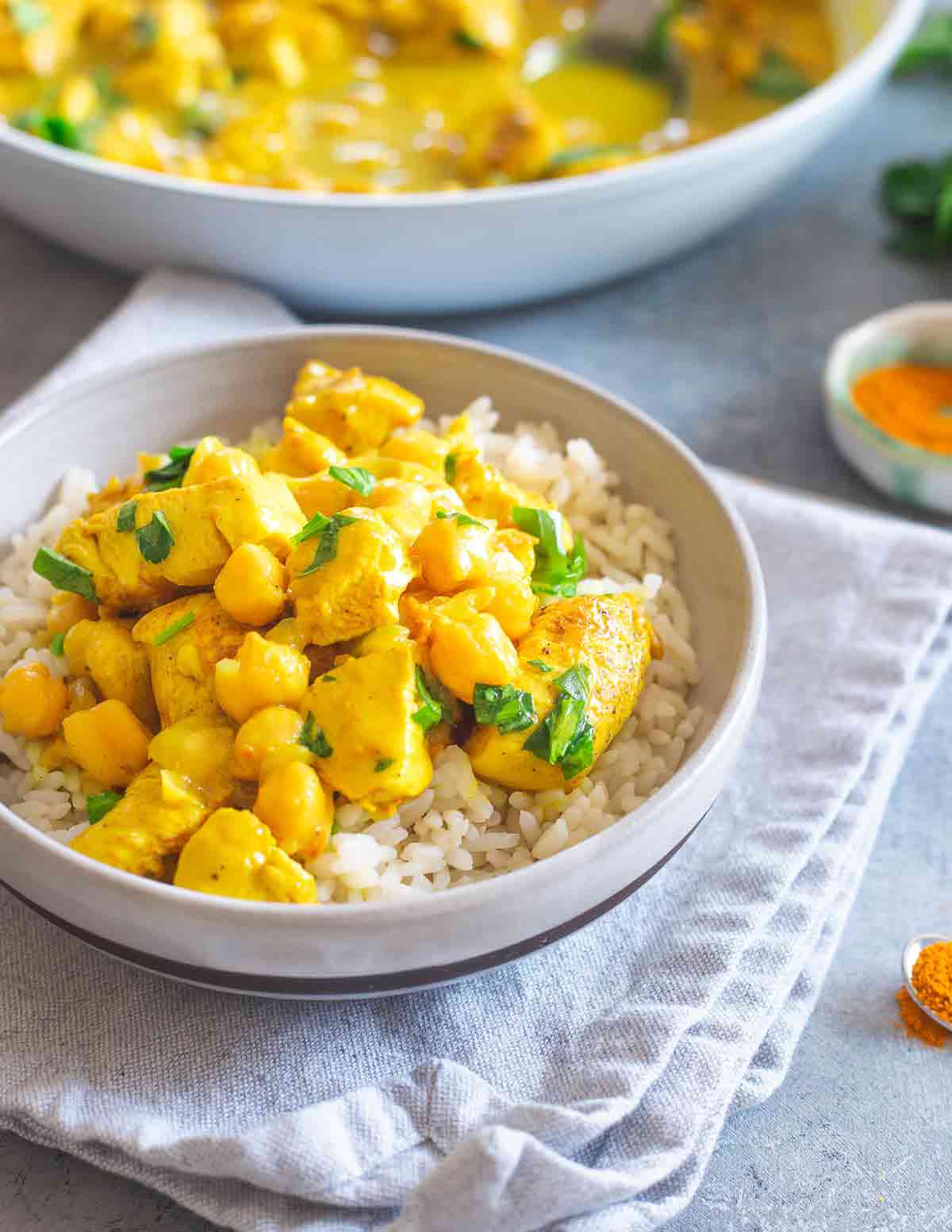 This creamy turmeric chicken is an easy one-skillet meal with hearty chickpeas. Serve it over rice with a cilantro garnish for a delicious dinner in under 30 minutes.