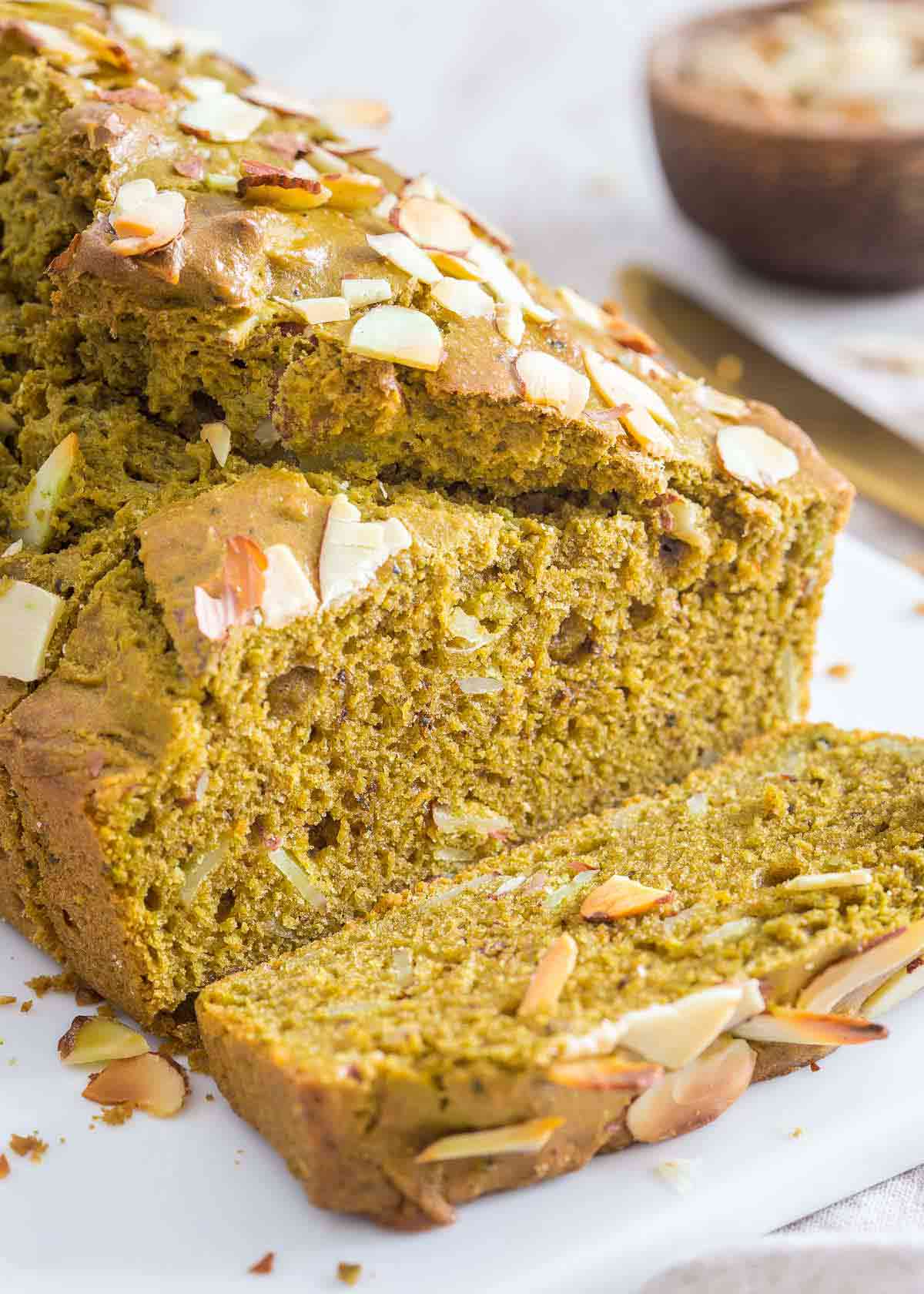 This matcha bread recipe uses almond flour, almond extract and sliced almonds for a lovely moist and aromatic quick bread with all the benefits of green tea powder.