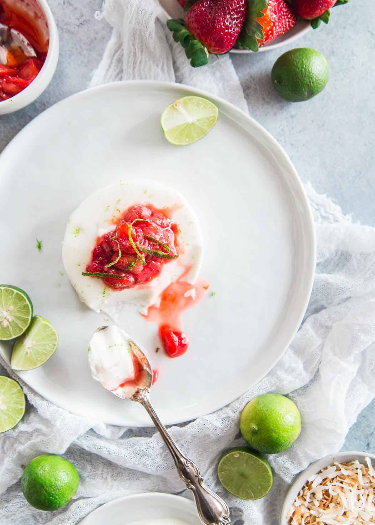 Coconut panna cotta is creamy and delicious with fresh key lime juice and zest and a zingy strawberry key lime topping.