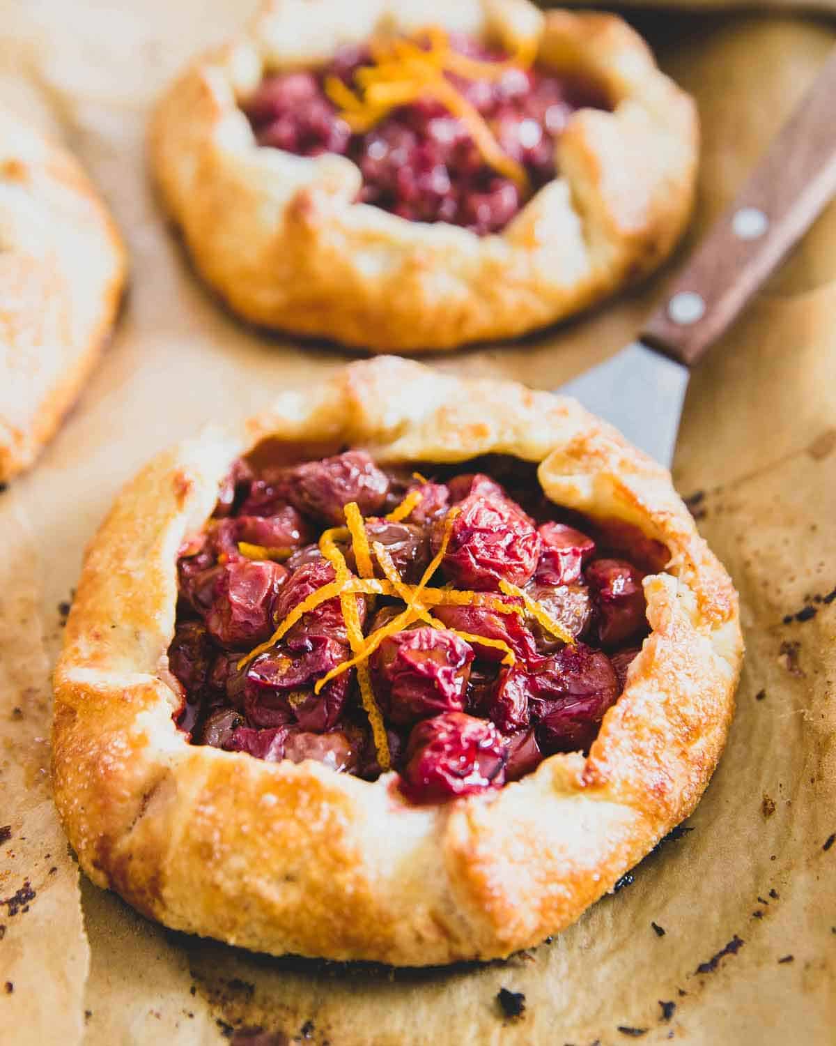 These mini Montmorency tart cherry galettes are filled with sour cherries and orange flavor to create beautiful rustic hand pies that are incredibly simple to make.