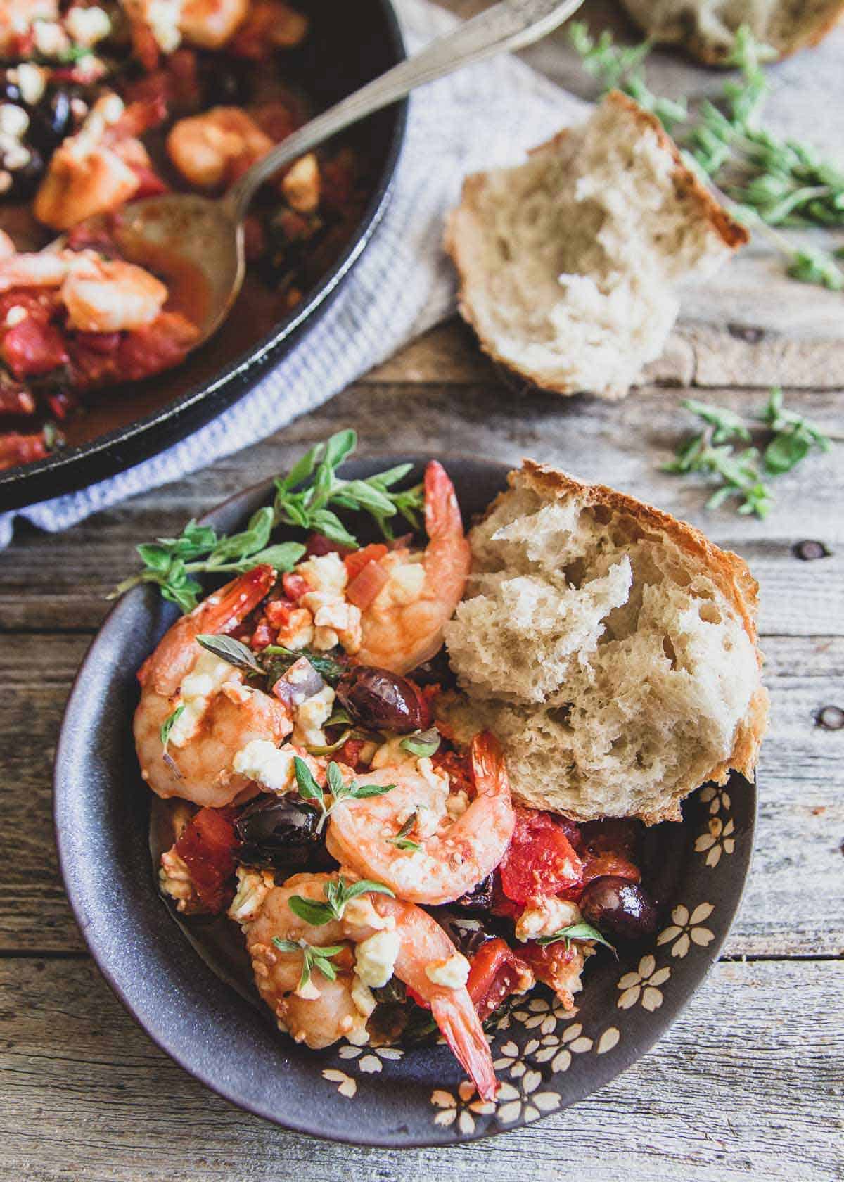 This Greek shrimp skillet is an easy 30 minute meal with tomatoes, spinach, Kalamata olives, feta and lots of fresh oregano and lemon flavor.