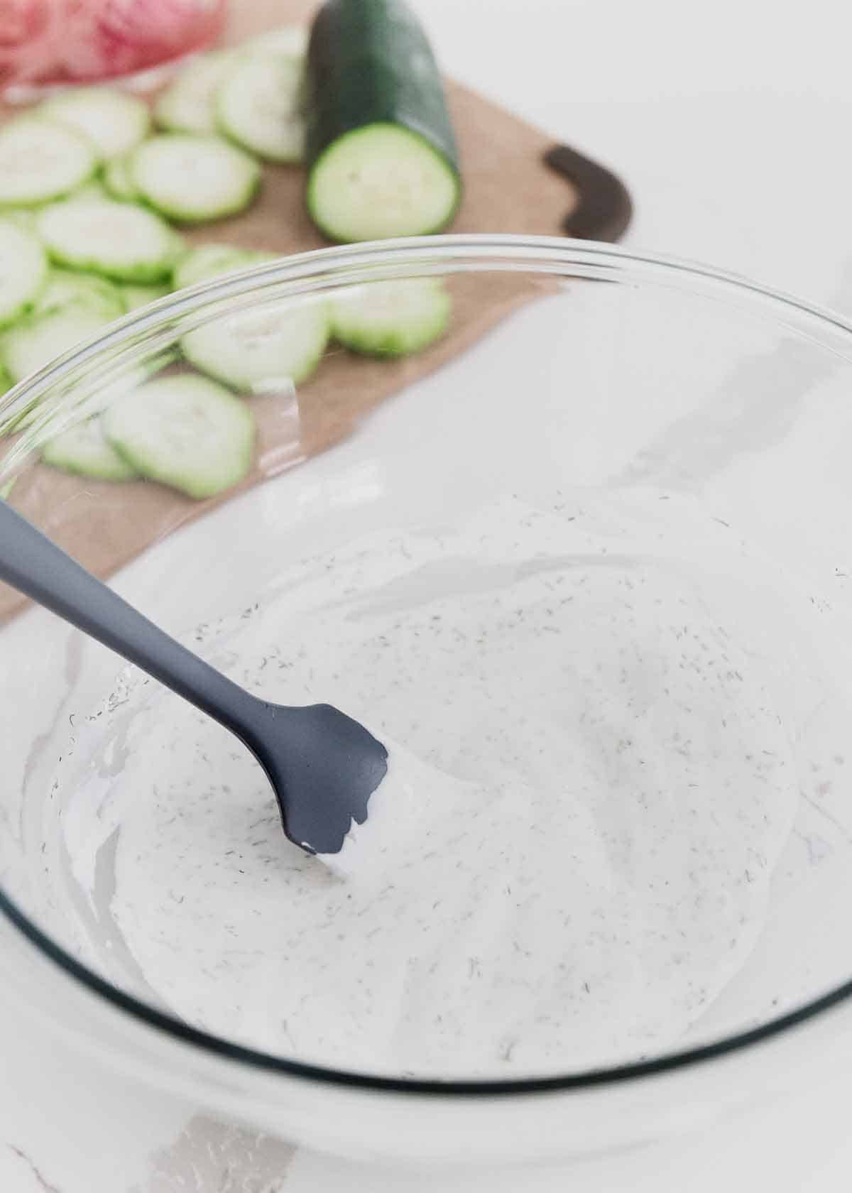 A Greek yogurt base makes this simple creamy cucumber and onion salad a healthier option summer.