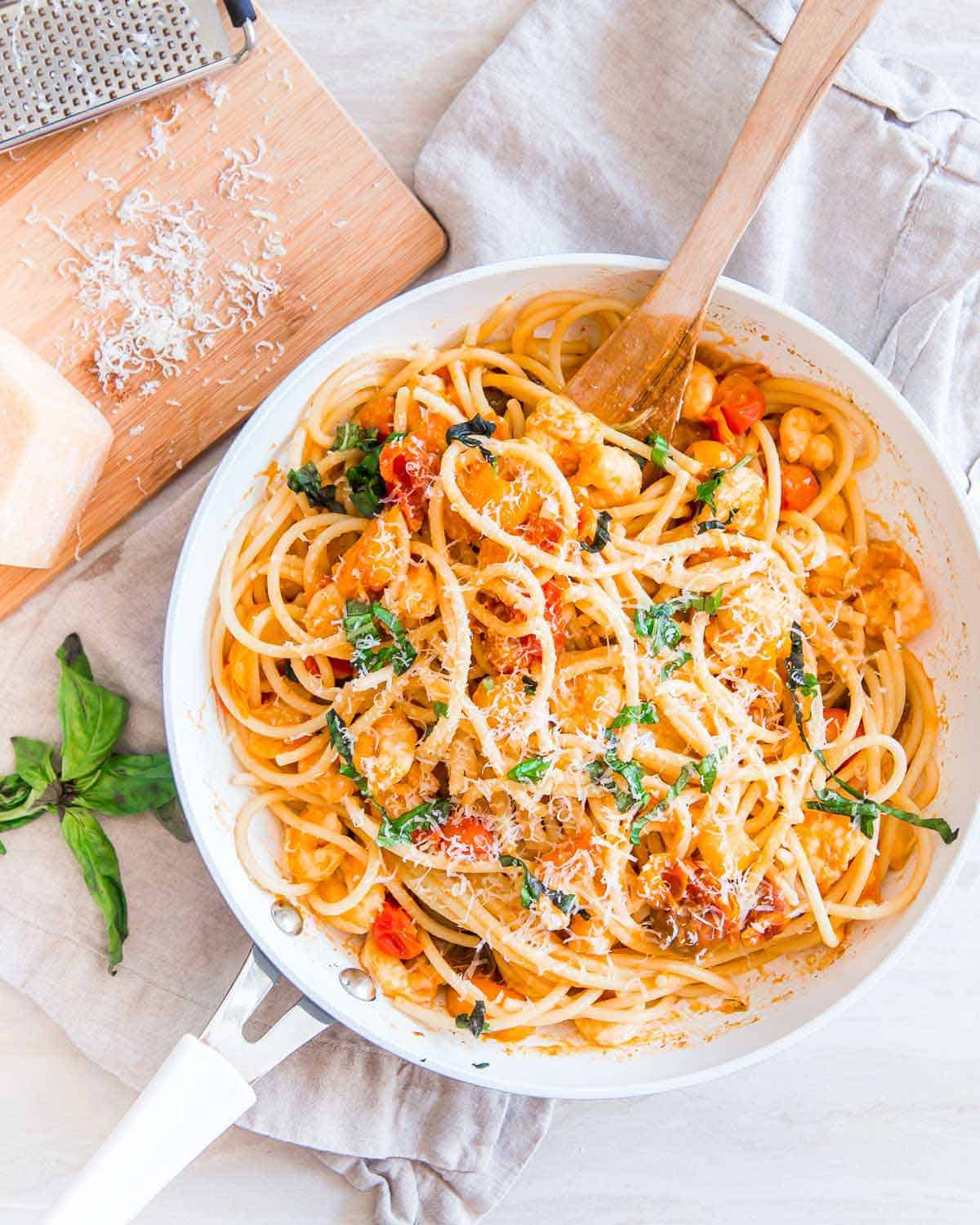 Easy, under 30 minute bucatini pasta recipe with garlic shrimp and cherry tomatoes.