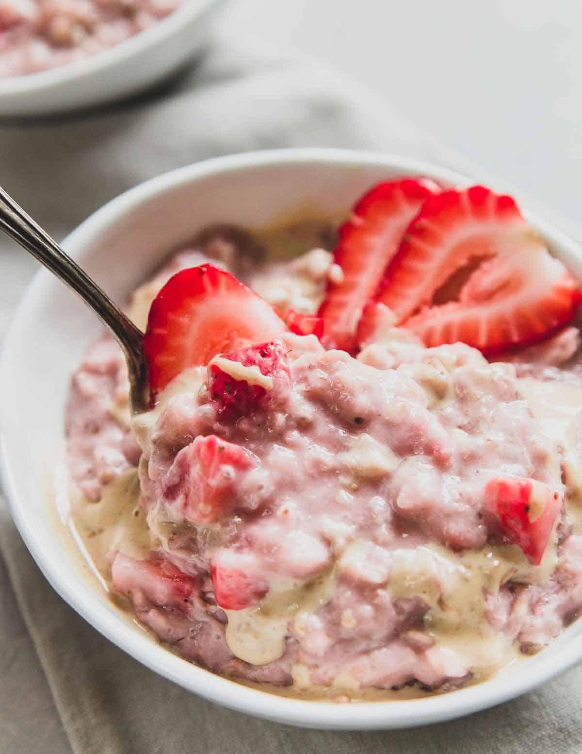 Strawberry oatmeal with fresh strawberries in a bowl.