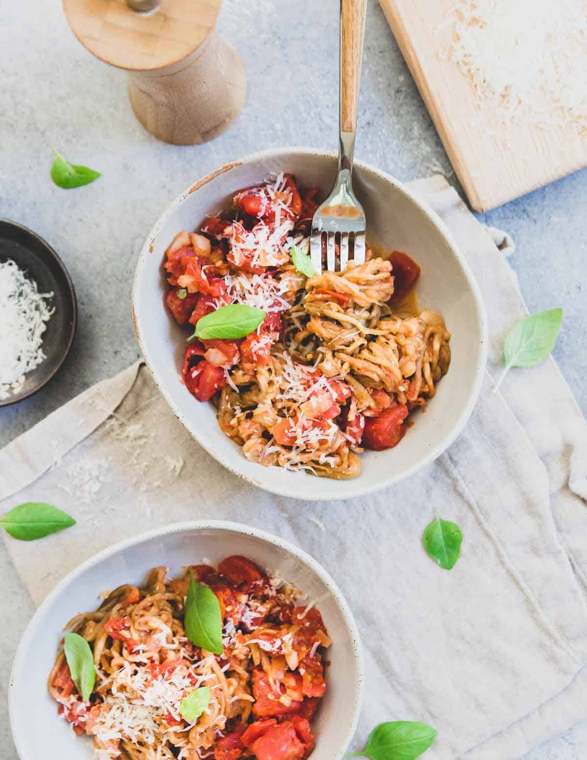 Eggplant noodles are tossed with a fresh chunky tomato basil sauce and topped with parmesan cheese.