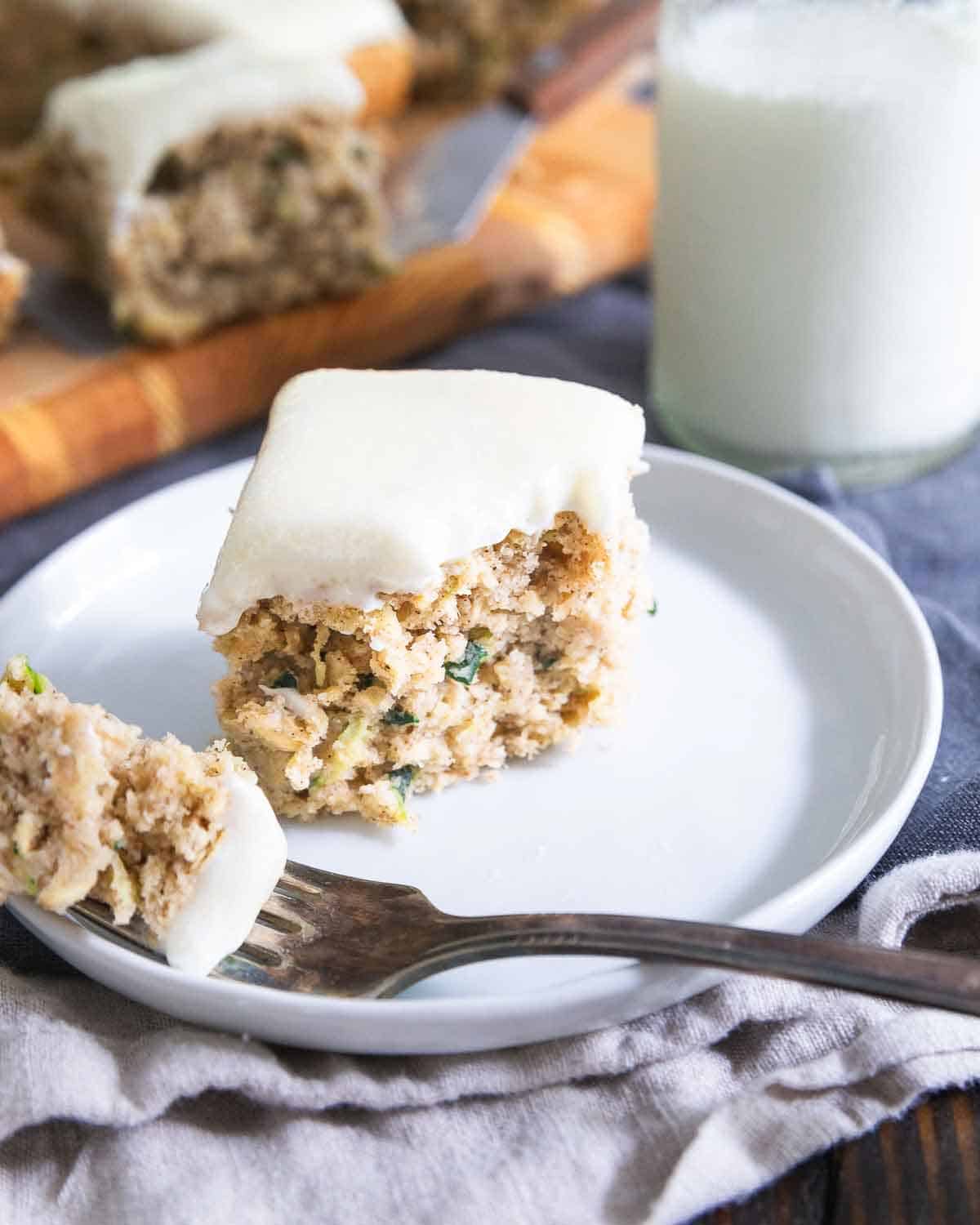 A moist, delicious crumb texture filled with spices and a sweet cream cheese frosting make this the best zucchini bar recipe!