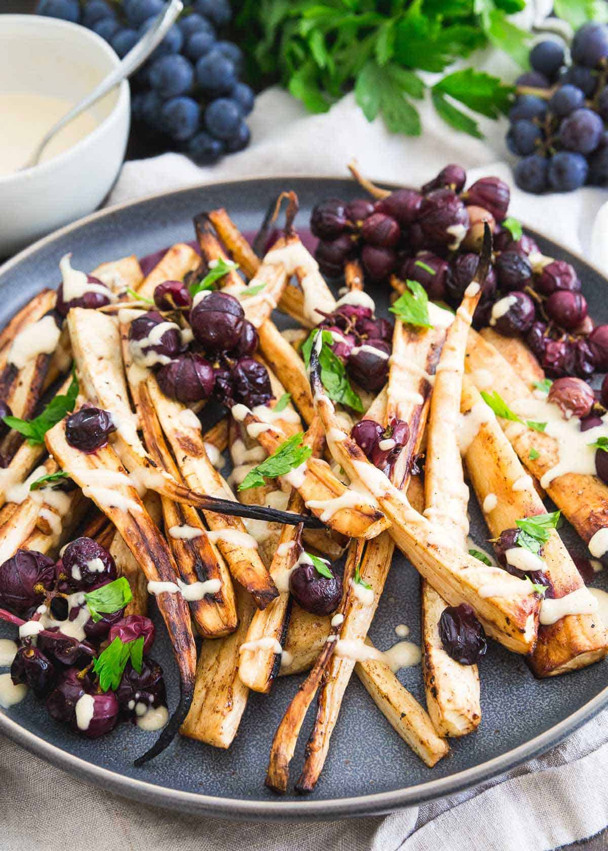 Roasted parsnips and concord grapes with cinnamon, brown sugar and a sweet hummus dressing.