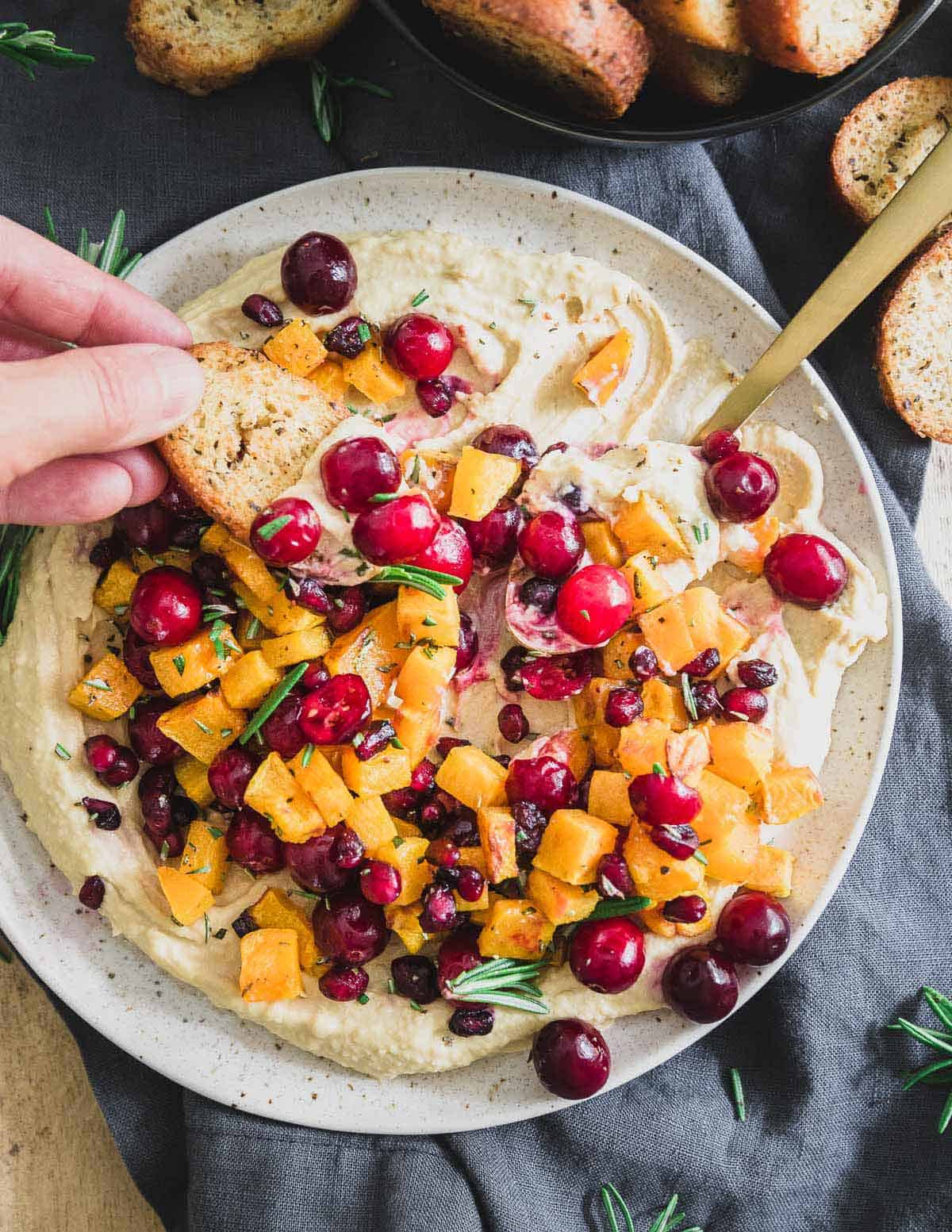 Serve this holiday butternut squash hummus with your favorite bread crisps, pita chips or even raw veggies for an impressive seasonal appetizer. 