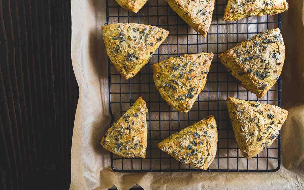 Hearty pumpkin scones filled with savory parmesan cheese, fresh herbs, pecans and pumpkin seeds.