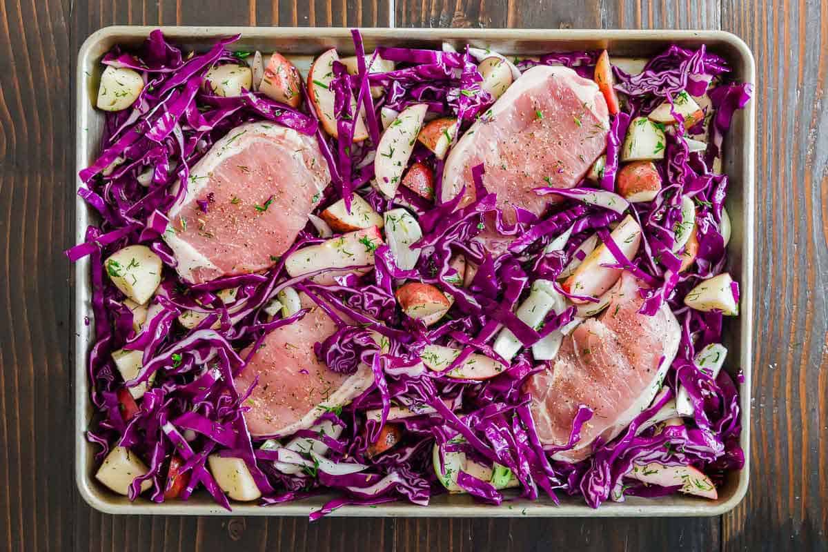 Thick cut boneless pork chops make a great sheet pan meal along with cabbage, apples and potatoes.