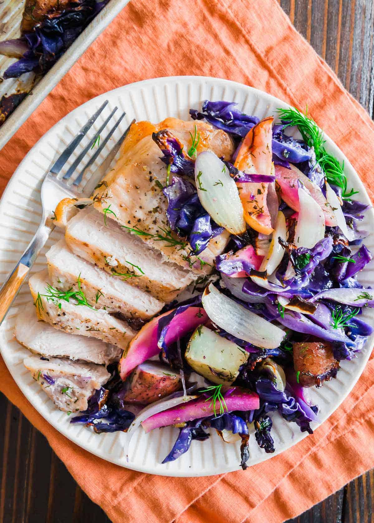 Juicy and tender pork chops are baked in the oven together with purple cabbage, potatoes and apples.