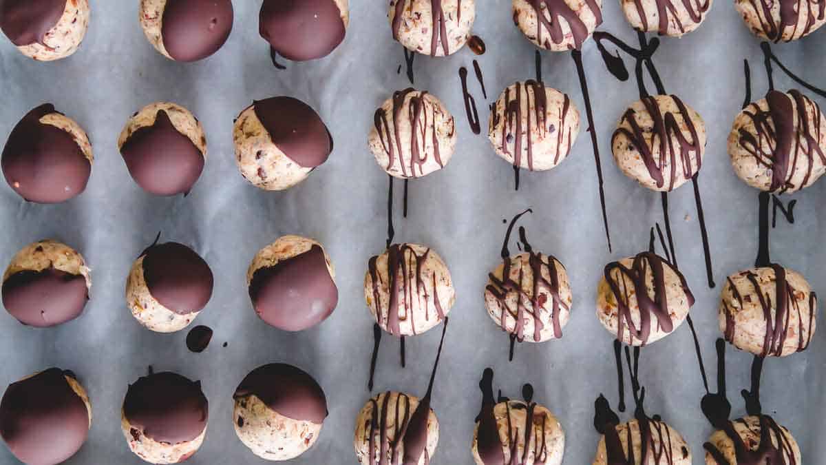 Drizzle cookie dough bites with melted chocolate for the ultimate healthy, gluten-free and vegan treat.