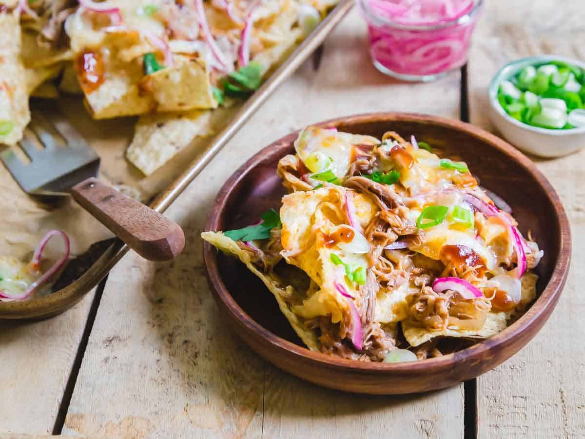 An easy recipe for BBQ pulled pork nachos to feed a crowd!