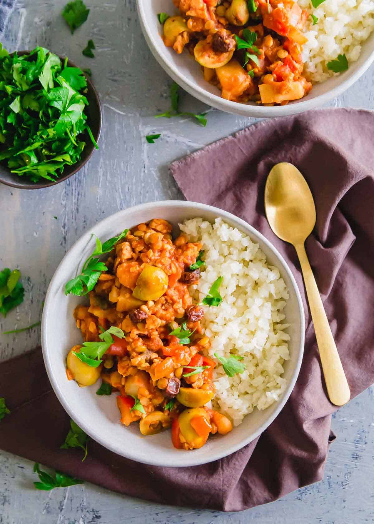 Vegan picadillo is a plant based version of this traditional Cuban recipe made with tempeh, lentils and potatoes. It's packed with big flavors from Spanish olives, capers, raisins and spices in a hearty tomato base.