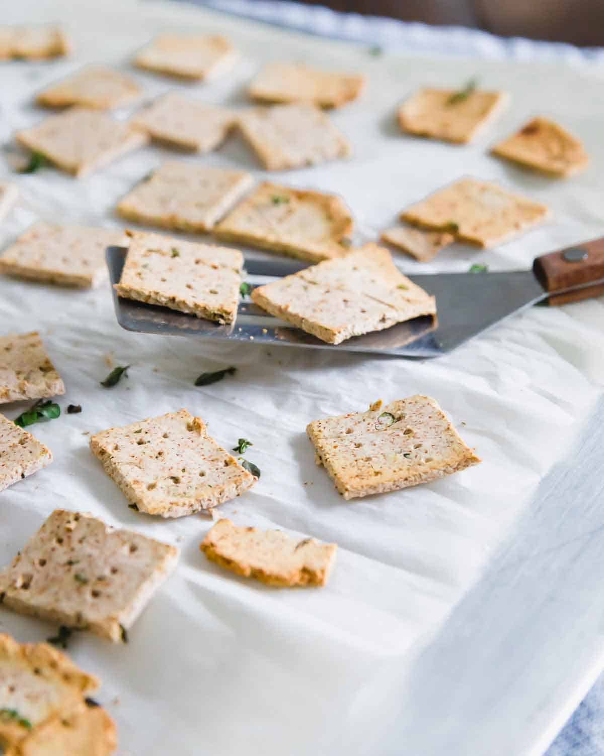 Crispy vegan almond pulp crackers with fresh herbs are a great way to use up leftover almond pulp from making nut milk at home.