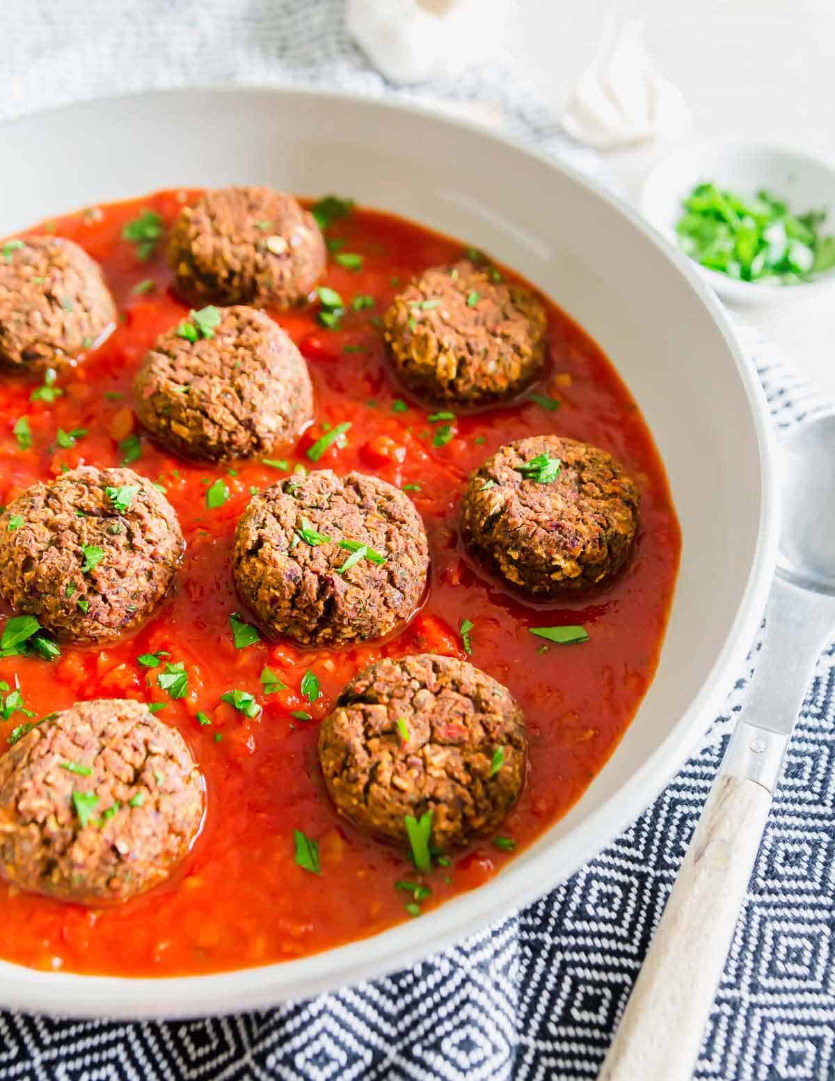 Looking for a vegan way to enjoy meatballs? Try these easy gluten-free, vegan black bean "meatballs" over pasta with your favorite tomato sauce.