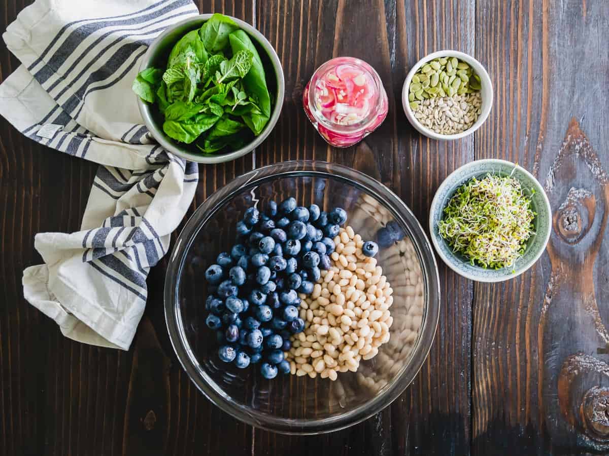 White bean and blueberry salad with pickled onions, seeds and fresh herbs.