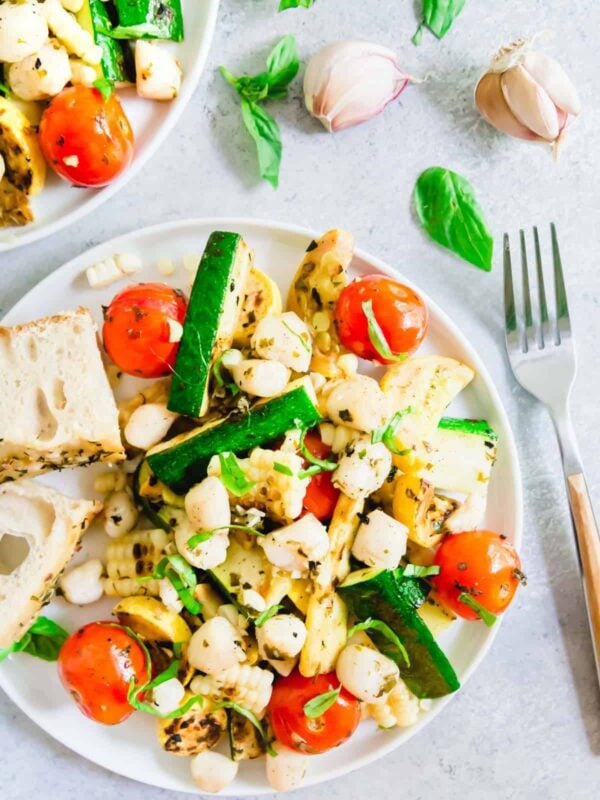 Grilled basil butter bay scallops with summer vegetables