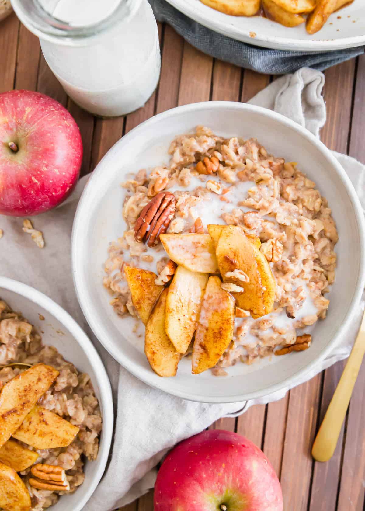 Apple cinnamon oatmeal is the perfect fall breakfast. It's packed with cooked apples and warming spices like cinnamon, nutmeg and ginger then topped with maple syrup sautéed apple slices and chopped pecans.