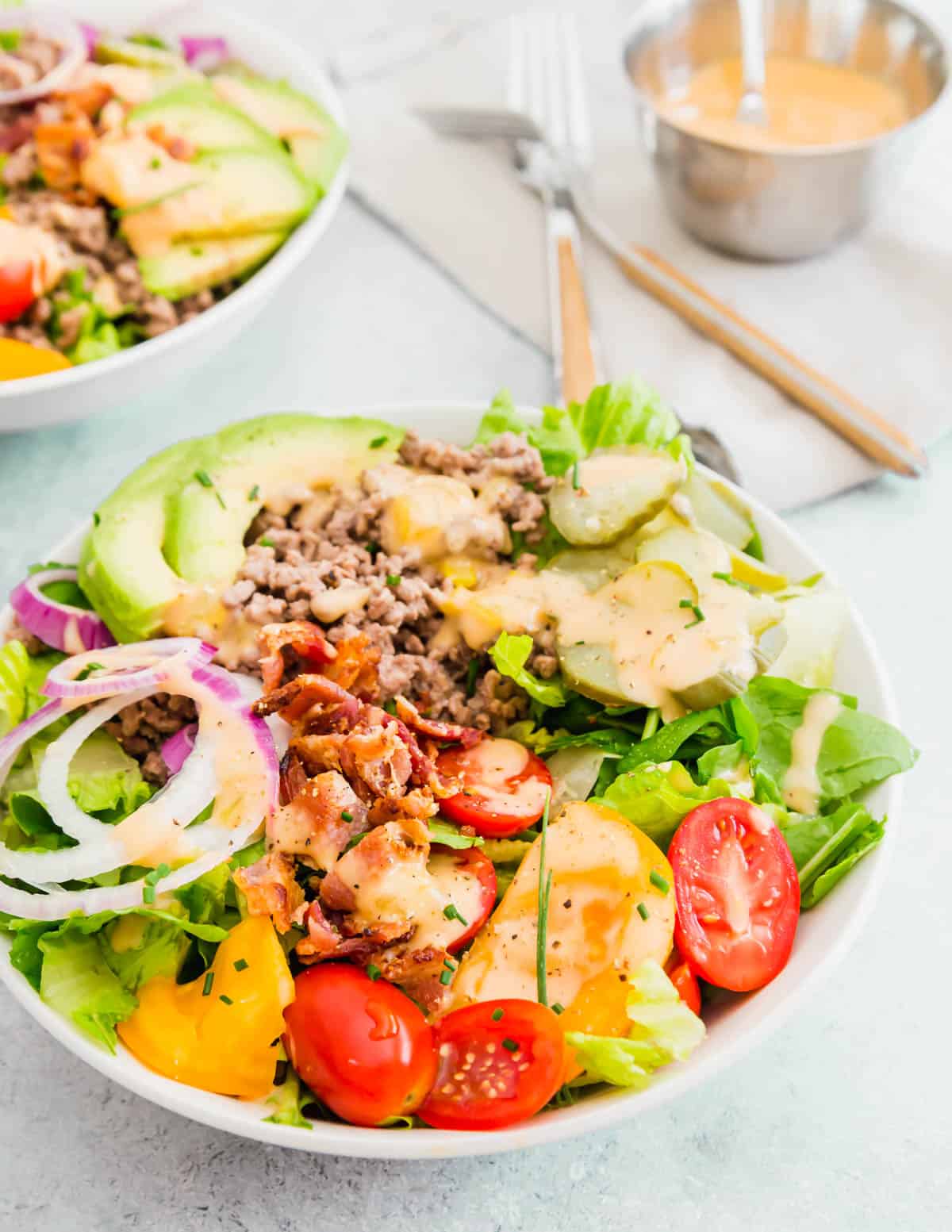Take all the elements from your favorite fast food burger, including the burger sauce and enjoy them atop a salad in these healthy burger bowls. 