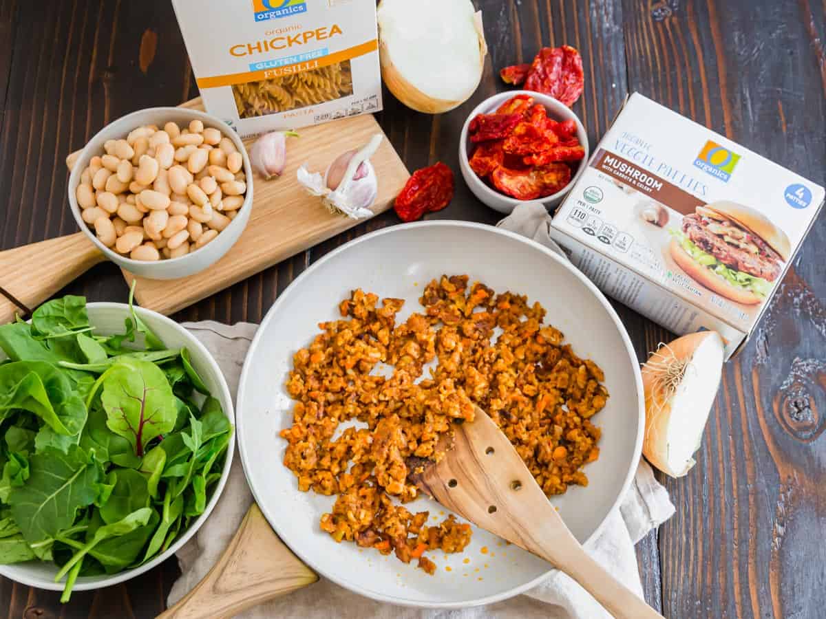 This vegetarian pasta includes sun-dried tomatoes, baby spinach greens, sautéed crumbled mushroom veggie burgers and a creamy white bean sauce.