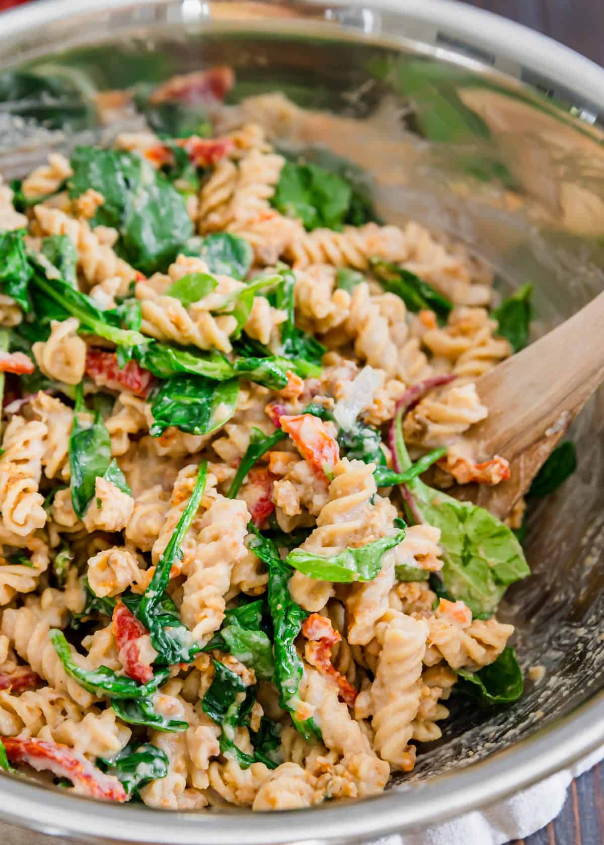 Baby spinach greens add a nice pop of color to this sun-dried tomato creamy white bean pasta recipe.