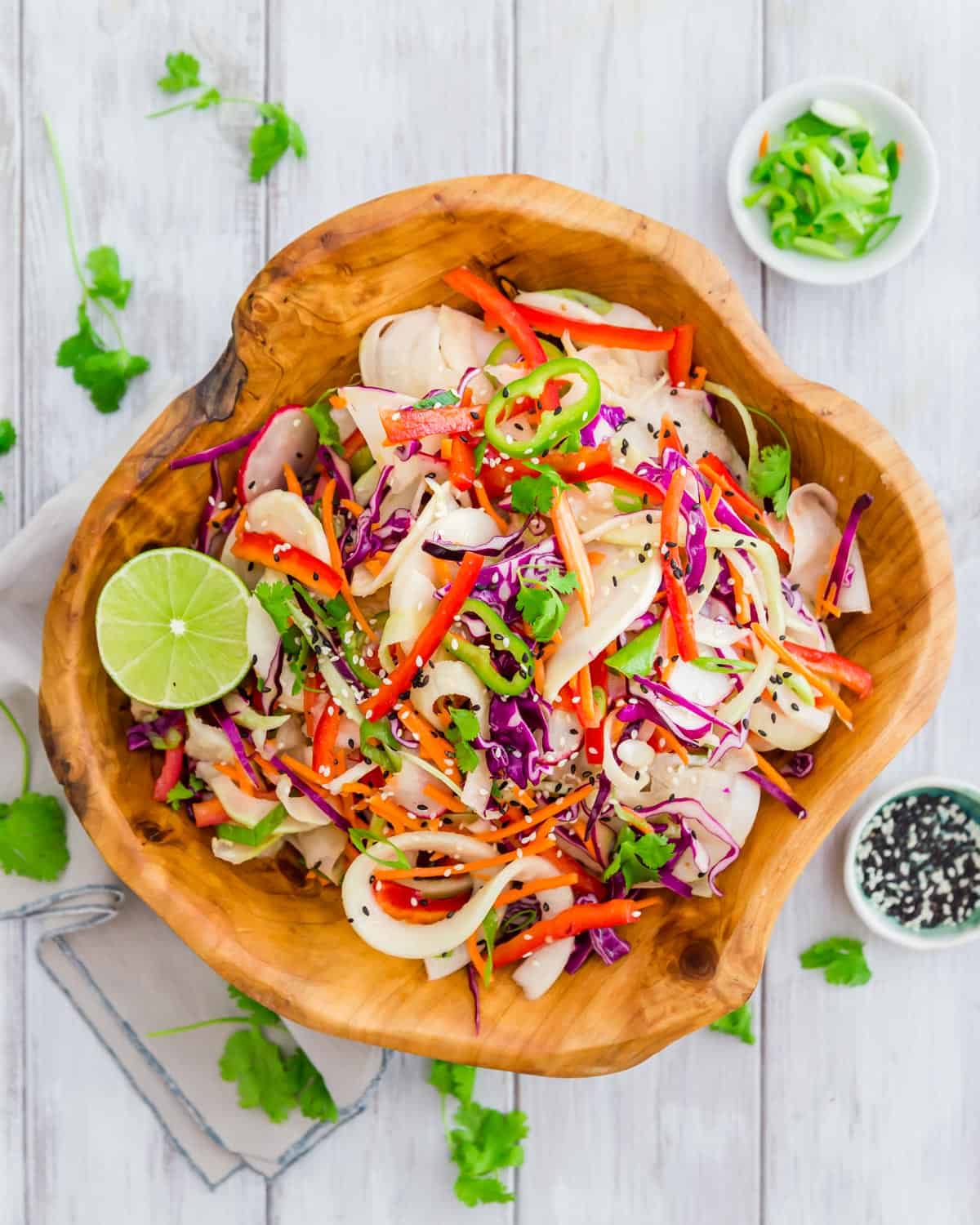 A colorful, easy salad with kohlrabi noodles, red cabbage, red pepper, carrots, radishes and green onion all tossed with a Thai inspired vinaigrette.