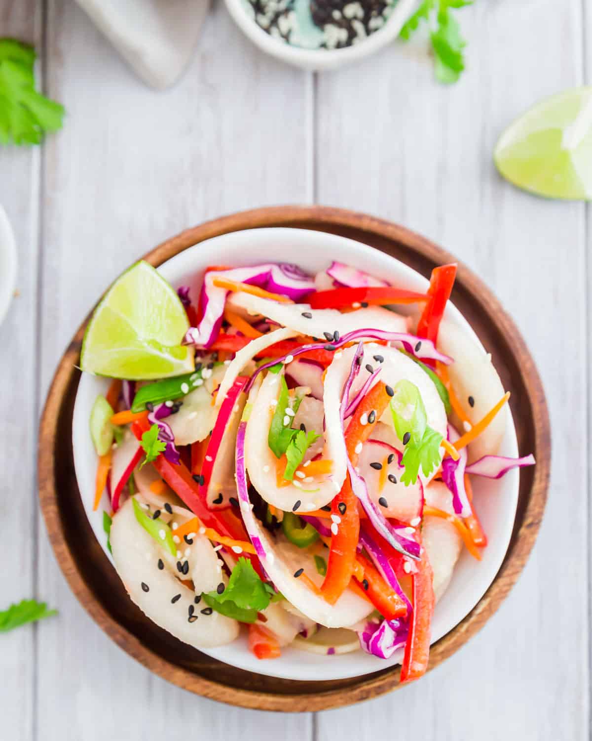 Make kohlrabi noodles by spiralizing the whole vegetable and then tossing with fresh vegetables in this easy Thai salad.