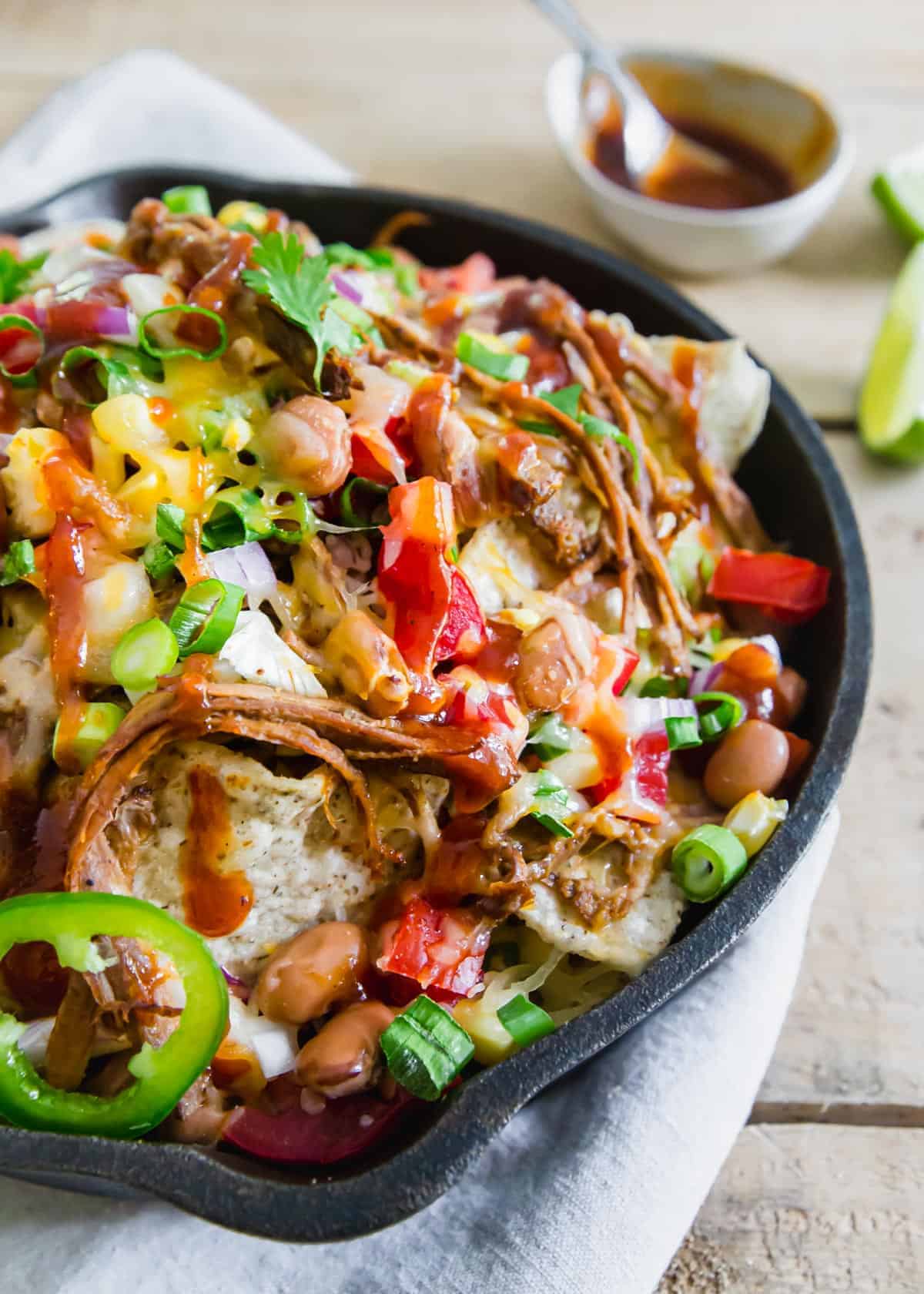 Use leftover shredded beef brisket to make these easy but insanely delicious BBQ brisket nachos. They're great as a party appetizer, dinner or addition to a game day spread and easy to customize to your topping preferences!