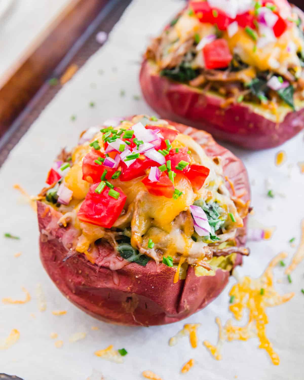 Soft, tender baked potatoes filled with BBQ brisket and loaded with cheesy toppings.