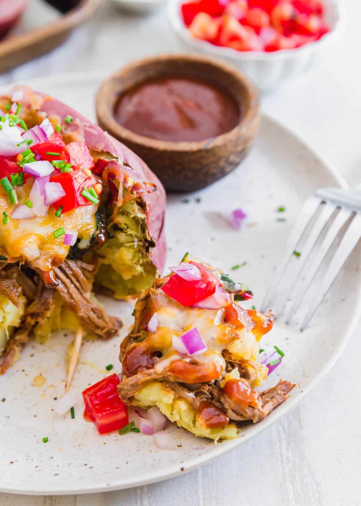 Loaded brisket baked potatoes served with BBQ sauce make an easy and delicious way to make a meal out of a baked potato!