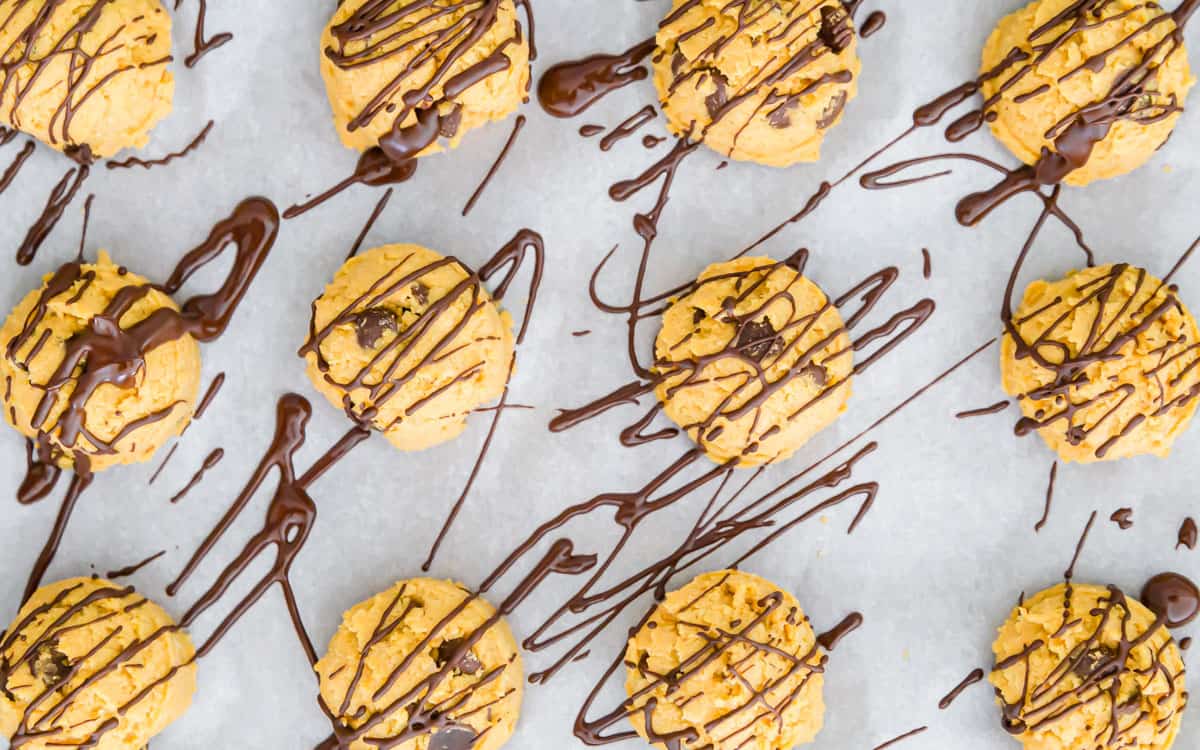 pumpkin cookie dough bites drizzled with melted chocolate