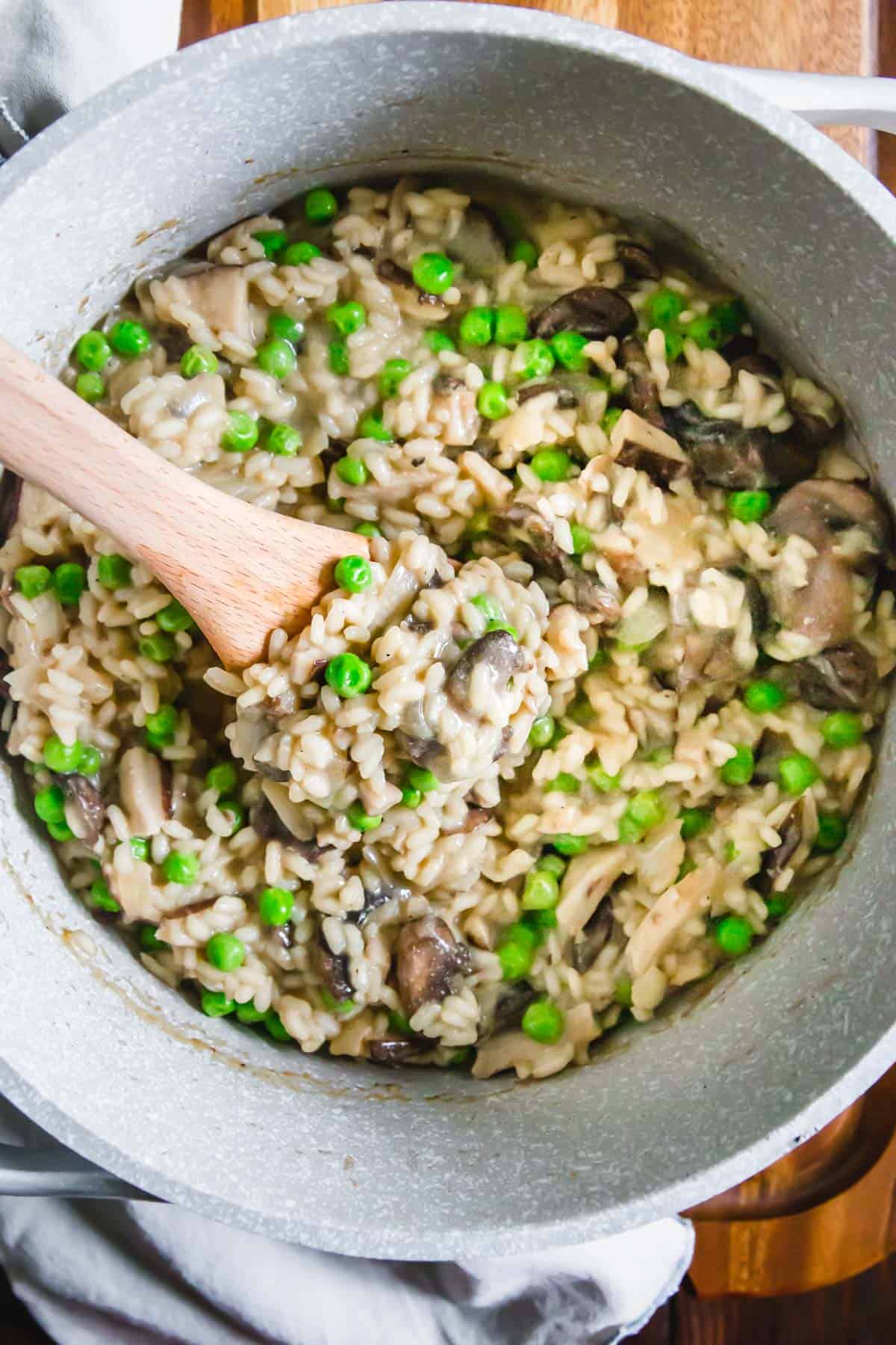 This vegan mushroom risotto with peas is insanely creamy and decadent without the use of any dairy! It's rich, comforting and packed with lots of umami flavors.