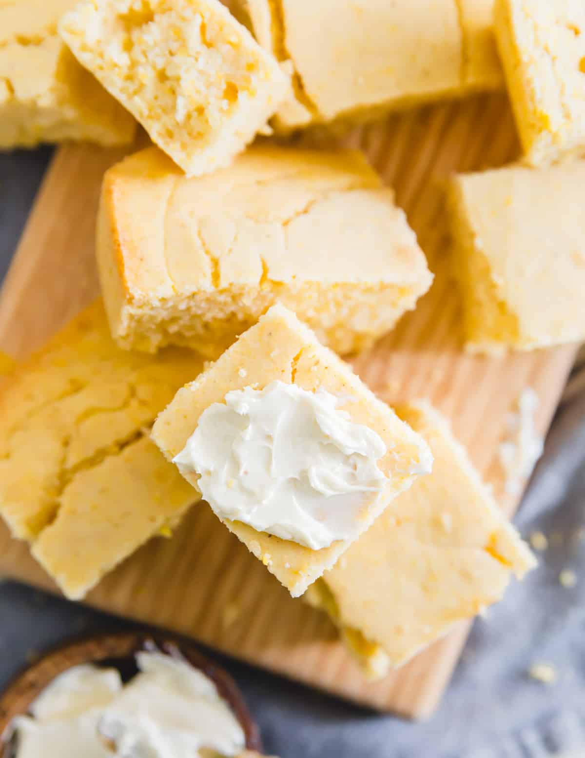 easy gluten-free vegan cornbread cut into pieces and served with softened butter
