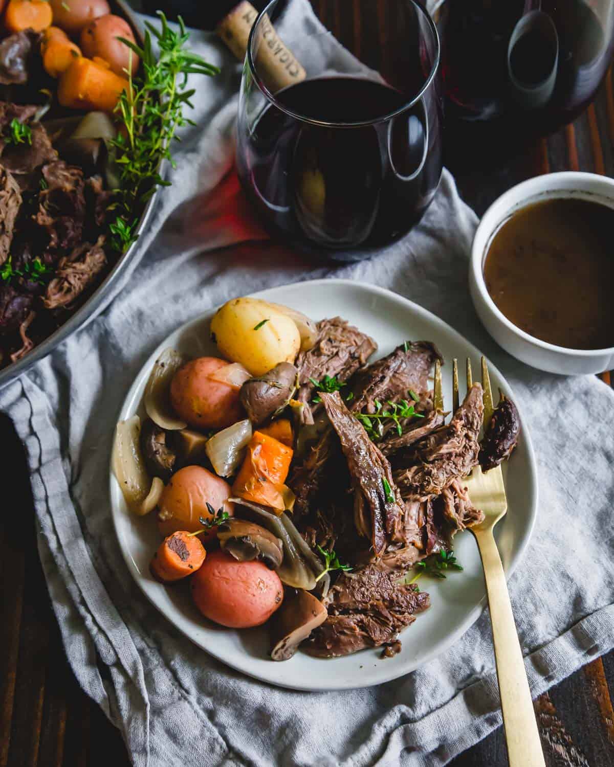 juicy and tender venison roast cooked in the Instant Pot with potatoes, mushrooms, onions and carrots in a red wine balsamic sauce